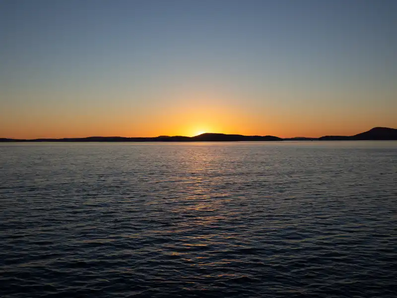 The sun setting over Puget Sound and Decatur Island
